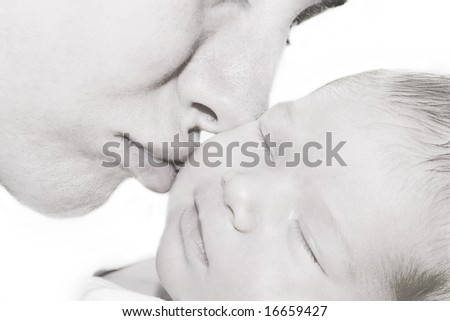 Baby and Mother. Mother kissing her baby.