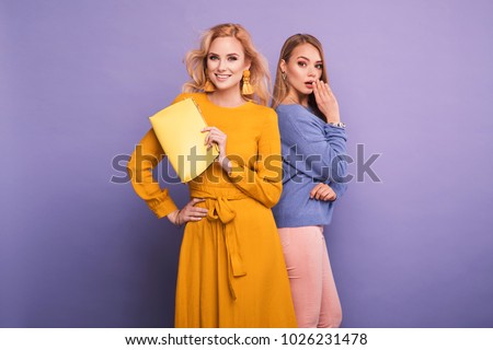 Two fashionable women in nice clothes. Fashion spring summer photo