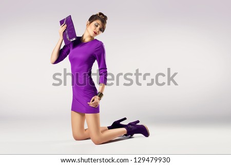 Beautiful woman in violet dress isolated on white