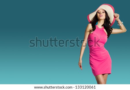Portrait Of Fashionable Girl With A Hat On His Head Over Blue Background