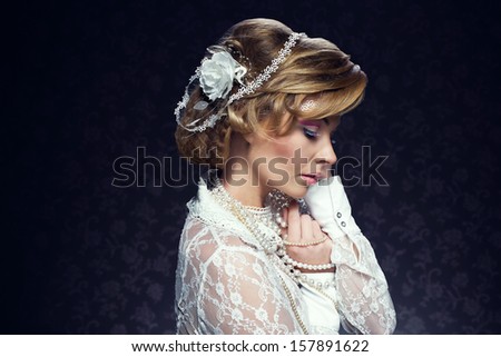Young woman in creative and artistic white make-up, perfect hairstyle