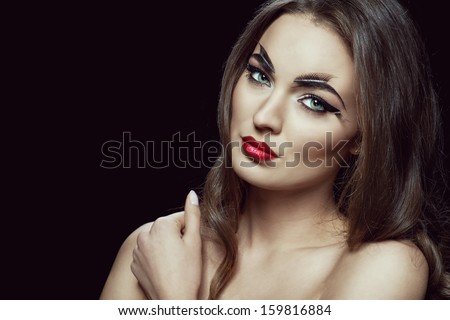 Fashion brunette model portrait with creative make-up red lips