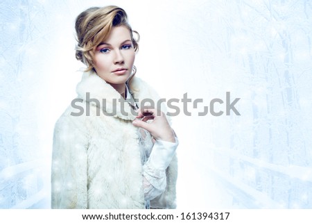 Elegant blonde woman wearing fur coat  in a winter weather concept