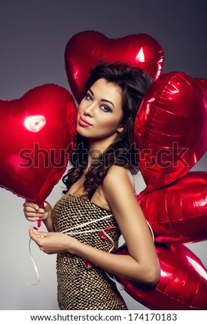 Beautiful Brunette Young Woman In Golden Dress With A Heart-Shaped Balloons