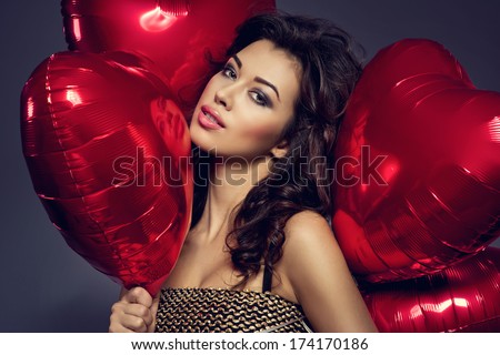 Beautiful Brunette Young Woman In Golden Dress With A Heart-Shaped Balloons