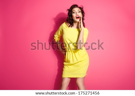 Glamorous girl wearing yellow dress, shouting