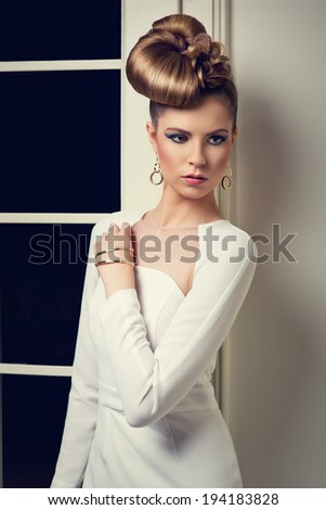 elegant woman in white dress with creative hairstyle