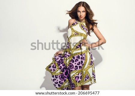 elegant woman in fancy dress posing in the studio. Cheetah pattern