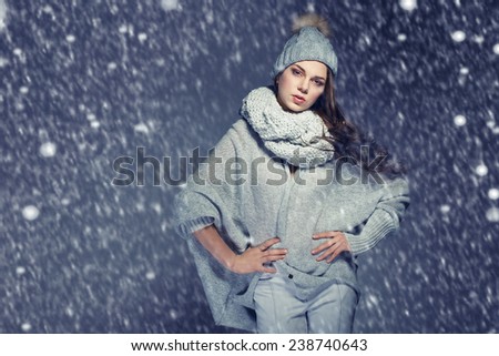 beautiful woman in winter clothes, sweater, cap, scarf