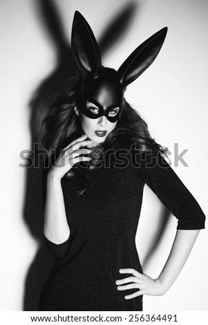sexy woman posing in black bunny mask