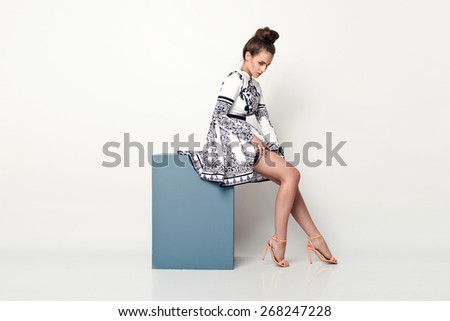 beautiful young  woman in nice spring dress, posing in studio. Fashion photo