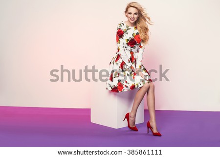 beautiful young blonde woman in nice spring dress posing in a studio. Fashion photo, high heel shoes