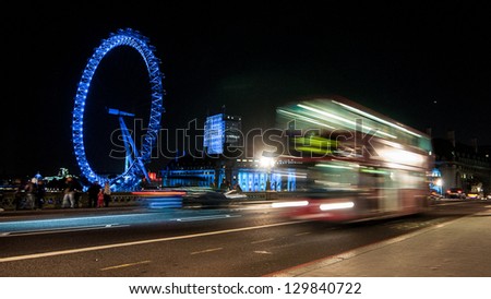 LONDON, ENGLAND - SEPTEMBER 26: Red Bus on Westminster Bridge with London Eye on September 26th 2012 in London. The London Bus is one of London\'s principal icons and is recognized worldwide.