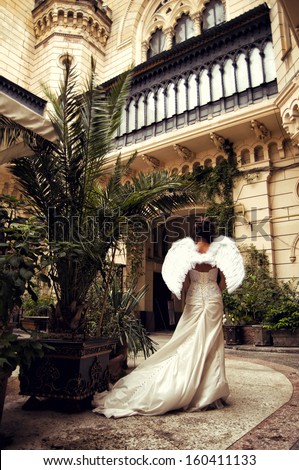 woman in wedding dress with angel wings