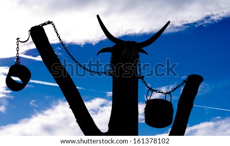 wood girder with blue background and chains