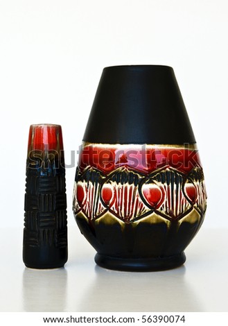 Israeli  black-red ceramic pair: two vases of 1950-th years with abstract carved and glazed image.Symbolizes couple: He and She; a Thick and a Thin etc. Isolated on white.