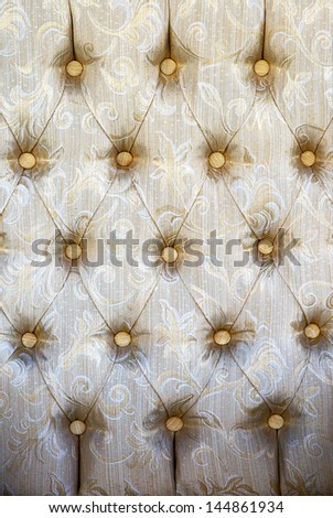 Pattern of retro furniture worn-out upholstery texture.Embossed background,light-green and beige  color with dark-beige graphical ornament.