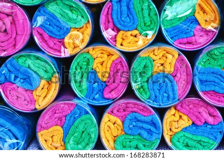 Close up of colorful towels in transparent plastic packaging. Pure and bright colors,cylindrical shapes, symmetrical rows. Good for background.
