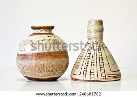 Israeli ceramic pair in brown tones: two vases of 1950-th years. Abstract pastel images. Symbolizes couple: He and She; brother and sister, bride and groom etc. Isolated on white.