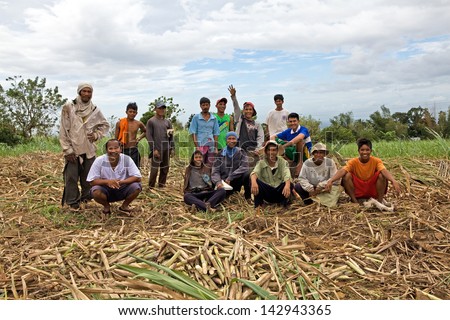 NEGOS ORIENTAL, PHILIPPINES - JANUARY 7, 2012 -  Filipino sugar cane workers pause for a group portrait on January 7, 2010 at Negros Oriental, Philippines. Sugar is the top export of the Philippines.