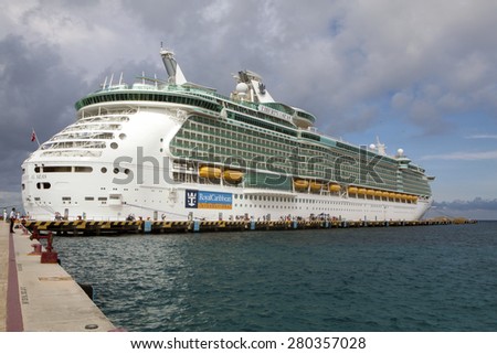 COZUMEL, MEXICO - JANUARY 15, 2015: Passengers walk along the pier going and coming from the ship to the beach town of Cozumel.