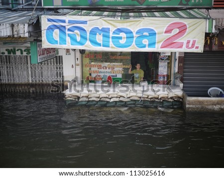 BANGKOK, THAILAND - NOV 17 - Thai flood hits Central of Thailand, overflow water while people use sand bag to protect house - at Pahonyothin road on November 17, 2011 in Bangkok, Thailand