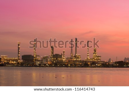 Petroleum oil refinery beside the river at twilight