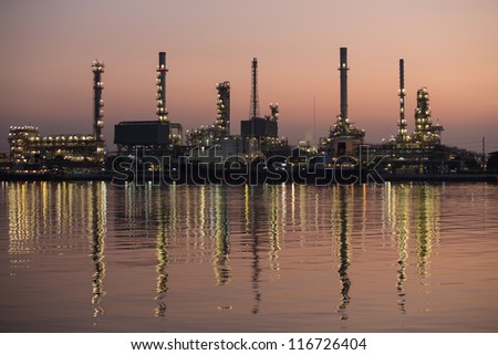Petroleum oil refinery beside the river at twilight