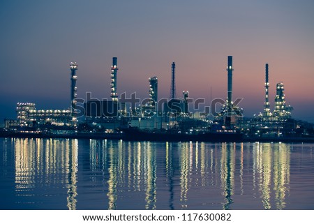 Petroleum oil refinery beside the river at sunrise