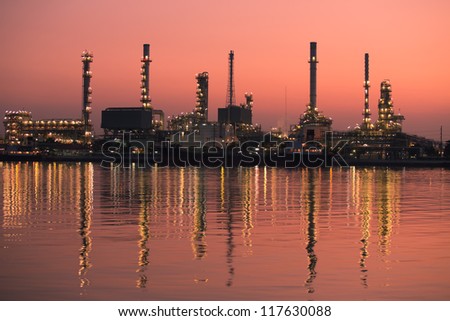 Petroleum oil refinery beside the river at sunrise