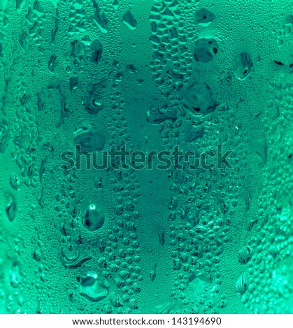 Blue green water drops on glass