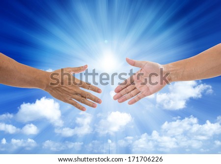 shaking hand with blue sky and sun light background