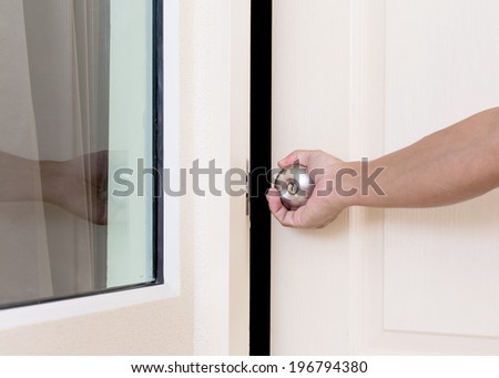 Hand holding door knob