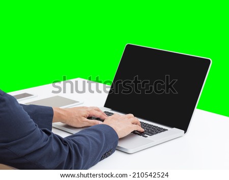 Business man hands typing on laptop computer with green screen background