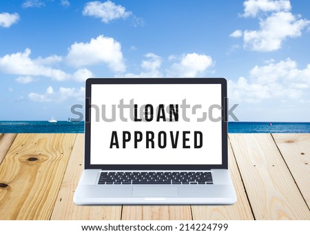 Loan application approved on Laptop computer screen with seascape background