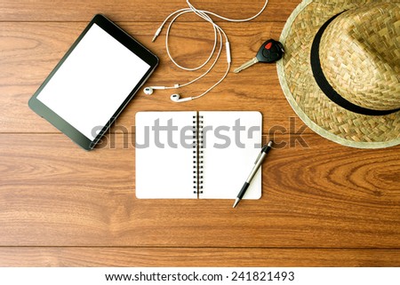 Mobile phone tablet and office accessories on wood background
