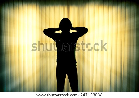 Silhouette of frustrated man with light ray effect background