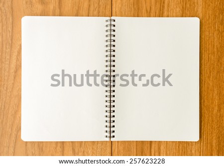 Spiral notebook on wood background