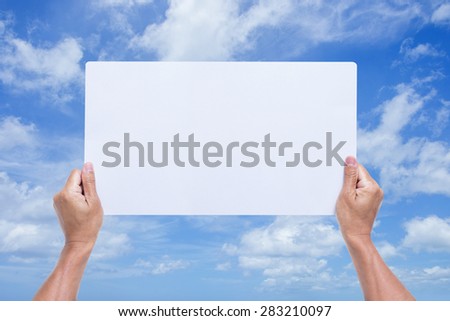Man hands holding blank banner with blue sky background