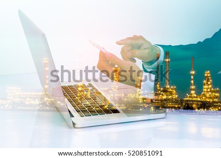 Double exposure of businessman and laptop computer with industry background