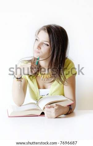 Girl student thinks on the book that she studies