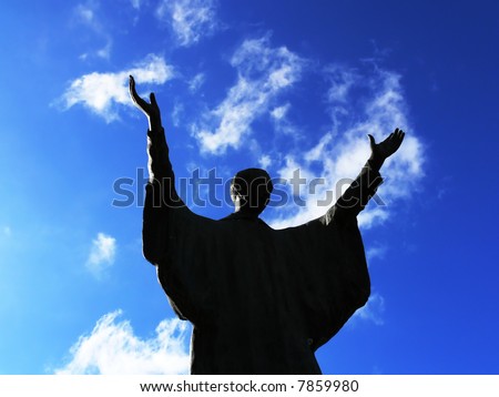 Silhouette of a man that praying with the arms direct to the sky