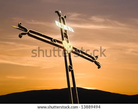 iron cross in the sky at sunset