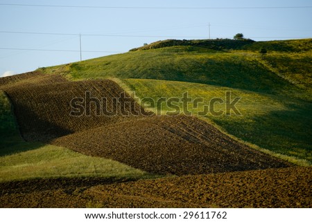 rolling landscaped for red plowed land and green field