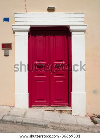 wooden door painted red against yellow wall