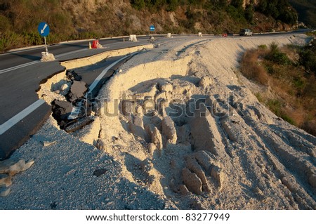 broken road by an earthquake or landslide (road sign)