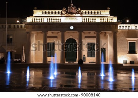coloured jets water of fountain and the Main Guard building by night in Valletta, Malta