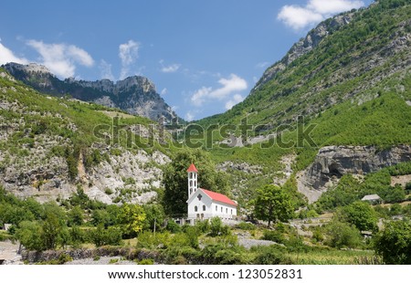 Church of Nikc in the Commune of Kelmend on background the mountains of North Albania