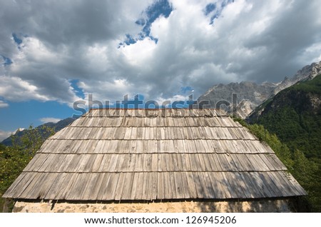 cloudscape on a old roof of wood shingles in Valbona Valley, Albania