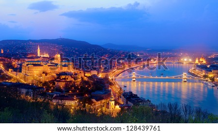 wide night view of Buda Castle and Chain Bridge on Danube River, Budapest